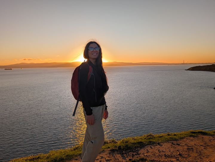 Lekshmi on a sea cliff at sunset