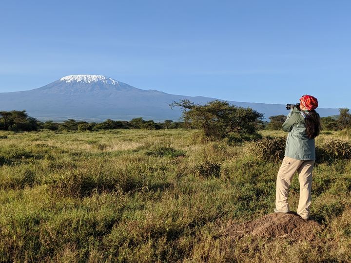 Lekshmi photographing Kilimanjaro across the savanna