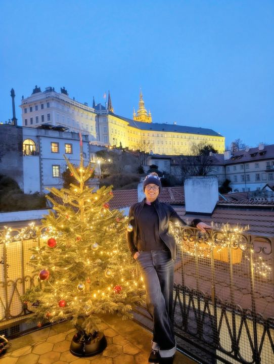 Lekshmi by a Christmas tree below Prague Castle