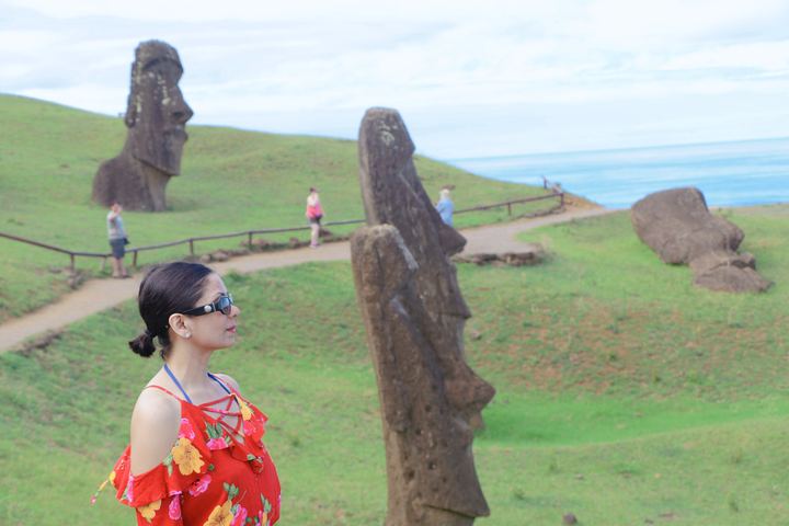 Lekshmi beside a moai on Rapa Nui